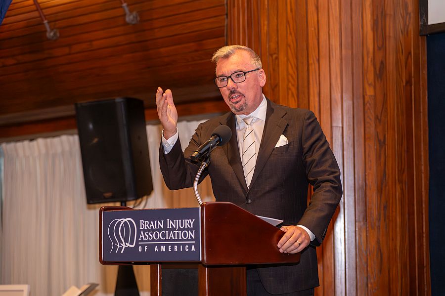 Rick Willis presents at the podium for the 2025 National Luminary of the Year event